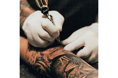 Arm being tattooed